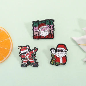 Three-piece Christmas enamel pin set featuring dabbing and classic Santa Claus designs