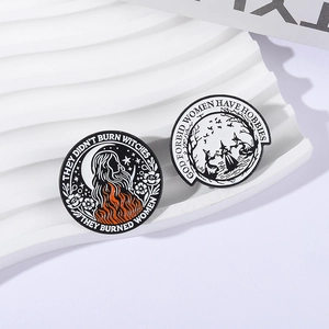 Creative black and white witch enamel pins with slogans on a white wavy stand