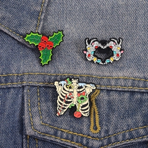 Creepy Cute Christmas Enamel Pins Set with Skull Holly and Skeleton Ribcage on Denim