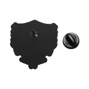 Macro view of the back side of a shield enamel pin with a black rubber clutch