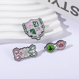 Whimsical enamel pin set featuring pink wizard shield, floral scissors, and glasses designs