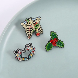 Christmas skull ribcage and holly berry enamel pin set with festive holiday light string