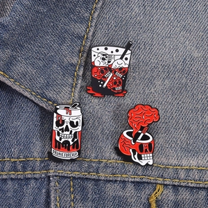 Drei Punk Totenkopf Getränke Emaille Pins Set auf blauer Jeansjacke im Gothic Stil