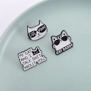 Funny black and white cat enamel pins featuring Cat Mom and Cat Daddy humorous quotes
