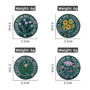 Detailed view of 3.1cm floral enamel pins with Spanish motivational quotes on white background