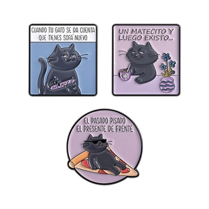 Cartoon black cat enamel pin badges with Spanish text on white background