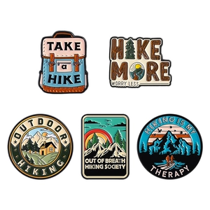 5-piece outdoor adventure enamel pin set with mountain, hiking gear, and nature designs