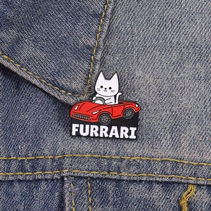 Creative white cat driving a red Furrari race car enamel pin on denim fabric