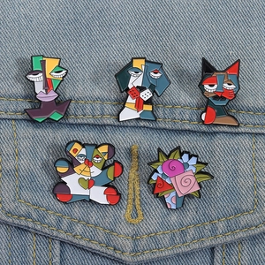 Artistic cubism animal enamel pin set with abstract faces and cat on denim jacket