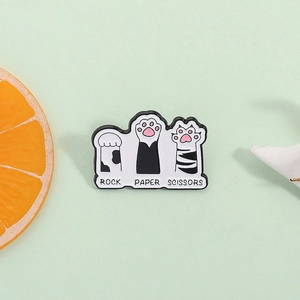 Cute cat paw enamel pin set with rock paper scissors game design on mint background