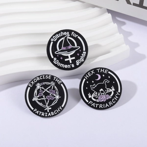 Set of three round enamel pins featuring witch hats, black cats, and mystical star patterns