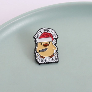 Christmas duck enamel pin with a knife and Santa hat featuring Don't Touch My HoHoHo text