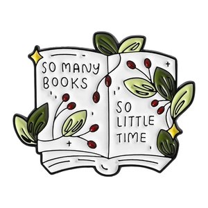 Enamel book brooch featuring green leaves and So Many Books So Little Time quote