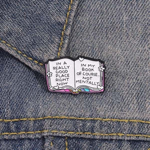 Creative enamel book pin with witty quote on denim background for book lovers