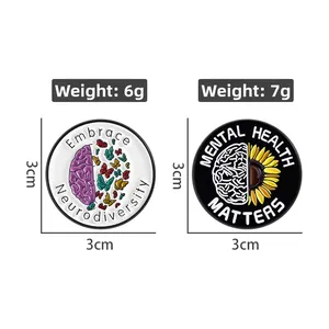 Detailed view of metal enamel pins for neurodiversity and mental health awareness