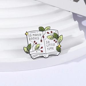 Enamel book brooch with green leaves and So Many Books So Little Time quote