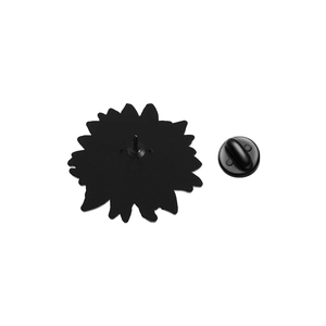 Detail of sunflower brooch back with sharp pin and secure black rubber clutch