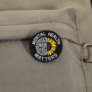 Detail view of Mental Health Matters enamel pin on a khaki canvas backpack pocket