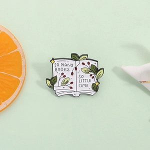 Creative enamel book badge featuring green plants and So Many Books So Little Time quote