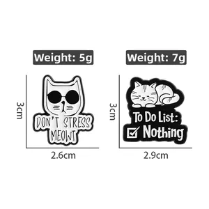 Detail of funny cat enamel pins with Don't Stress Meowt and To Do List Nothing text