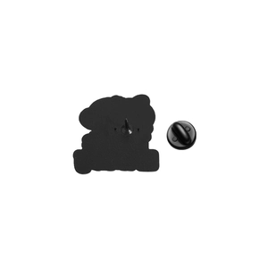Macro detail of the matte black alloy back of a cat badge with a rubber clutch closure