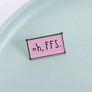 Pink rectangular enamel brooch with 'oh, FFS.' text slogan and black metal edges