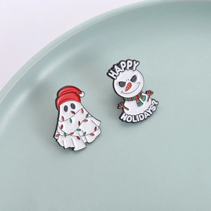 Cartoon ghost and snowman enamel pins set with Happy Holidays text in a ceramic dish