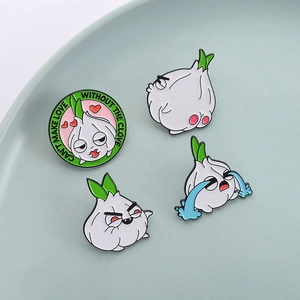 Funny garlic enamel pins set featuring cartoon facial expressions on a blue ceramic plate