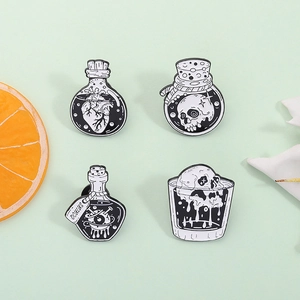 Gothic black and white enamel pins featuring skull and heart potion bottle designs
