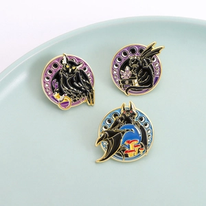 Fantasy enamel pin set with bat owl and magic book designs on a ceramic tray