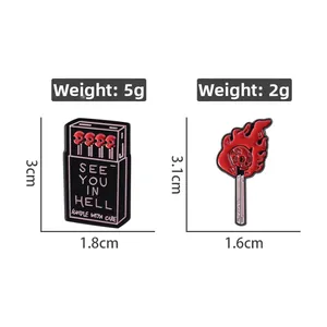 Detail view of gothic matchbox enamel pins with skeleton and See You In Hell text