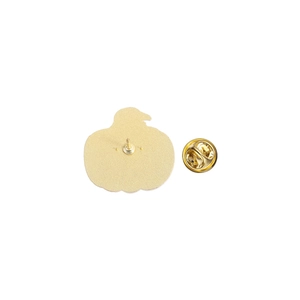 Detailed back view of golden pumpkin brooch with butterfly clutch pin on white background