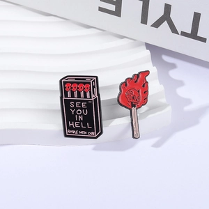 Gothic skull fire matches enamel pins set with See You In Hell text on white stone base