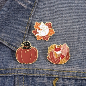 Detailed enamel pins featuring cat, crow, and fox on blue denim for autumn style