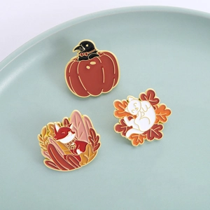 Autumn enamel pins set featuring a black crow, red fox, and white cat with maple leaves