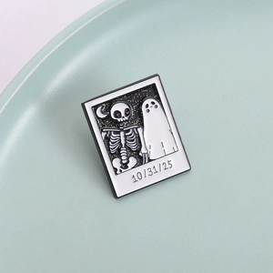 Halloween skull and ghost enamel pin in polaroid photo style with black and white motifs