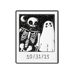 Halloween polaroid enamel pin featuring skull ghost with glitter sky and 10/31/25 date