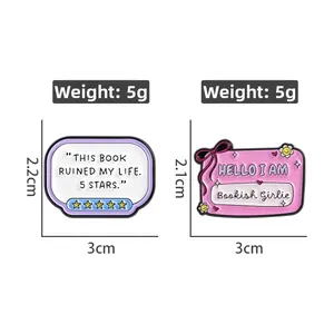 Detail of two literary enamel pins with 'Bookish Girlie' and 5-star review designs