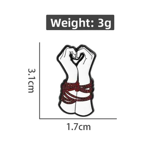 Artistic hands heart enamel pin with red rope detail and size dimensions 3.1cm x 1.7cm