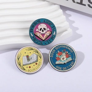 Set of 3 round enamel pins featuring skeleton, flowers, and book lover reading themes