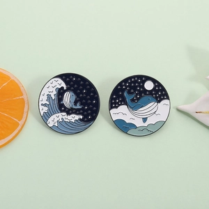 Japanese style blue whale enamel pins featuring moonlit clouds and ocean waves design