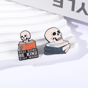 Gothic skull and books enamel pin set with motivational quotes on white stand