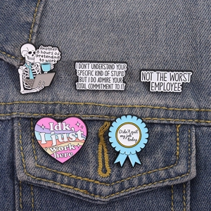 Funny workplace enamel pins with skeleton and office quotes on blue denim jacket pocket