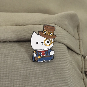 Detailed view of steampunk cartoon cat enamel pin on olive canvas bag strap