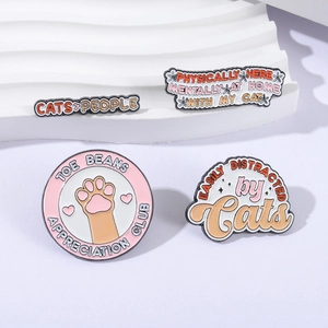 Cute enamel cat lapel pin set with paw prints and funny quotes on white display
