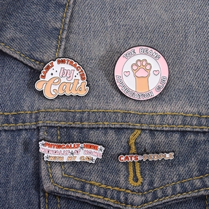 Cute cat enamel pins with funny quotes on denim jacket for cat lovers and backpack decor