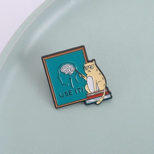 Cartoon Orange Katze Lehrer Emaille Pin mit Gehirnzitat auf blauem Teller