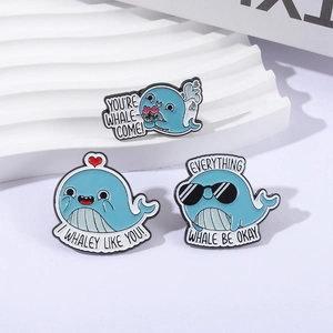 Cute set of three blue whale enamel pins with funny pun quotes on a white background