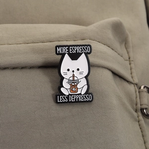 Cute white cat enamel pin with More Espresso Less Depresso text on canvas backpack