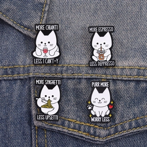 Set of four funny white cat enamel pins with coffee and wine quotes on denim fabric